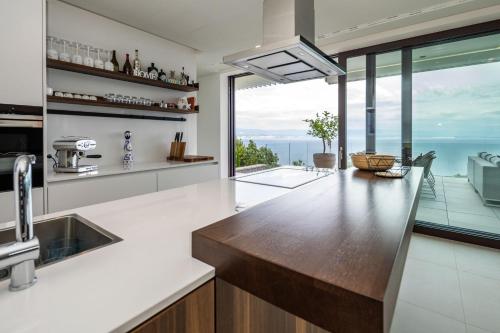 a kitchen with a counter with a view of the ocean at Stunning Kvarner Villa 5 Bedrooms Villa Aura Caesar Stunning Sea Views & Private Pool Opatija in Medveja