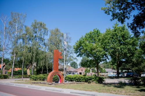 a large orange sign on the side of a road at Natuurpoort van Loon in Loon op Zand