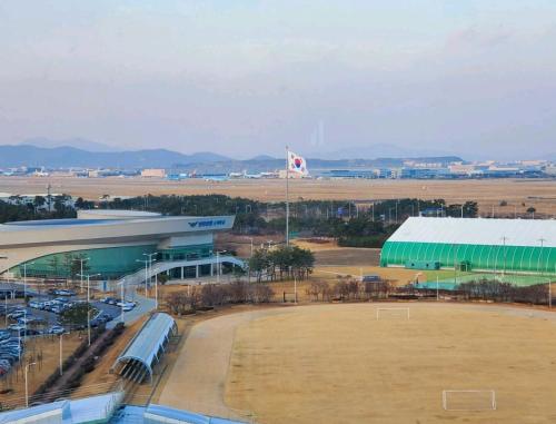 an airport with a large building and a large field at Cozy - Good Vibes Studio in Incheon