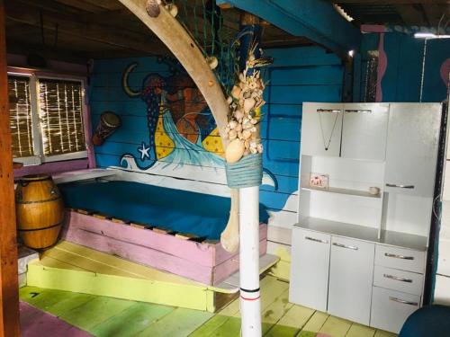 una cocina con una pintura en la pared en Casa Candombe y Mar, en Barra de Valizas
