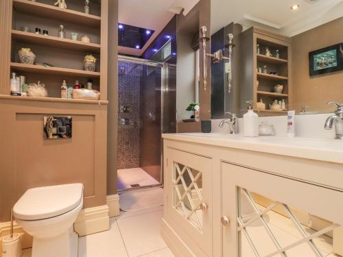 a bathroom with a toilet and a sink and a shower at Westwood House in Lytham St Annes