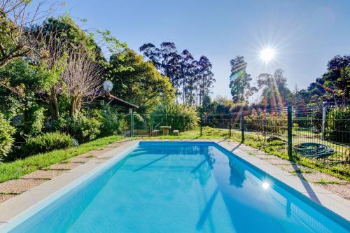 a swimming pool in the backyard of a house at Casa do Moinho Rural campo e praia , 9 pessoas, animais benvindos in Espinho
