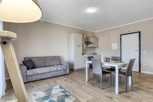 a living room with a table and chairs and a couch at Asso Residence Ospedale in Terni