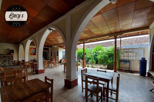 a restaurant with a table and chairs in a room at Casa Lucys Hostal in Granada
