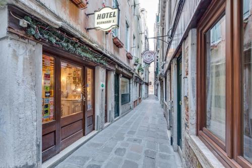 an empty street in an old town with shops at Hotel Bernardi Semenzato in Venice