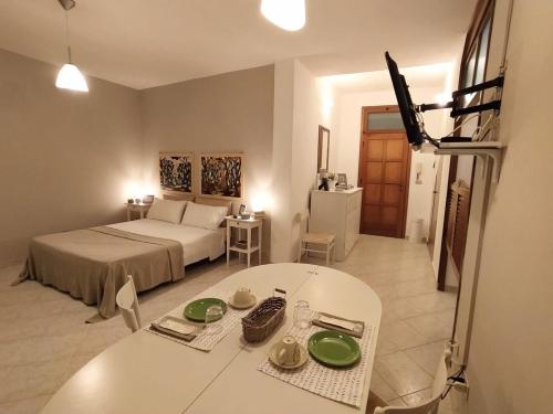 a bedroom with a bed and a white table and a room at A due passi dal mare in Moneglia
