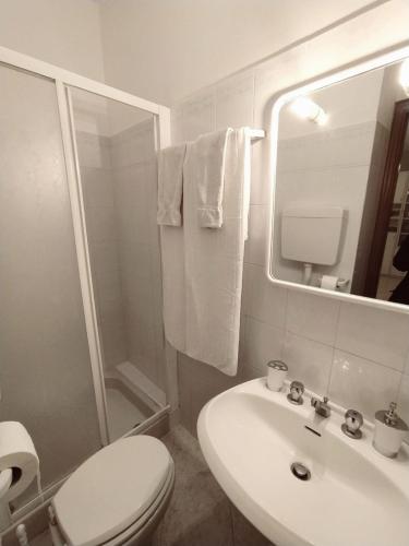 a bathroom with a sink and a toilet and a mirror at A due passi dal mare in Moneglia
