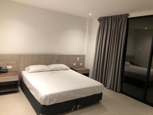 Un pat sau paturi într-o cameră la Hotel Tucunaré