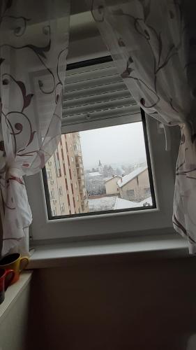 a window in a room with a view of a building at Apartman Luna in Valjevo