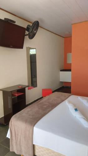 a hotel room with a bed and a mirror at Pousada Casa Doce Vida in Águas de Lindóia