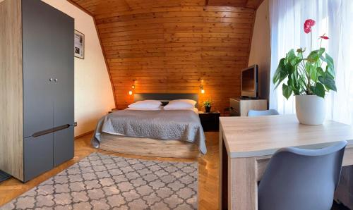 a bedroom with a bed and a desk and a table at Pensjonat Paradise in Karpacz