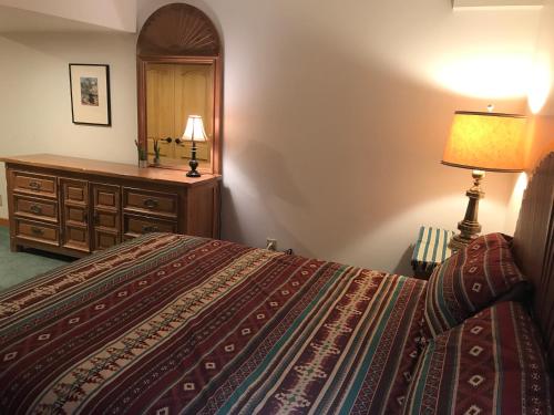 a bedroom with a bed and a dresser and a lamp at 4047 Wyandot Street in Denver