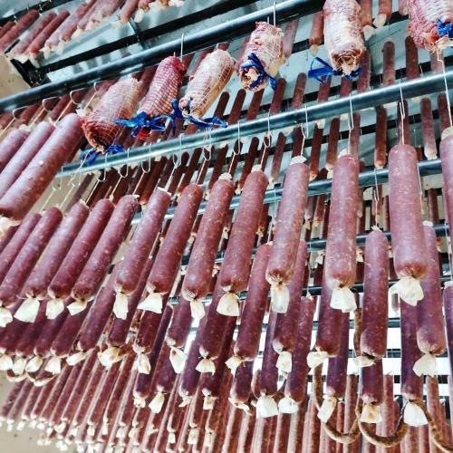 a bunch of sausages are lined up on a rack at Rtanj Kopaonik Eco Resort & Spa in Kopaonik