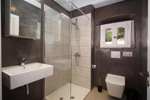 a bathroom with a shower and a sink and a toilet at Mathilda's House in Tselendáta