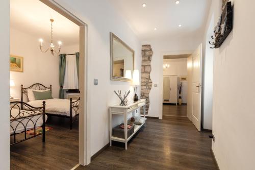 a bedroom with a bed and a mirror in a room at Apartman Arca in Rovinj