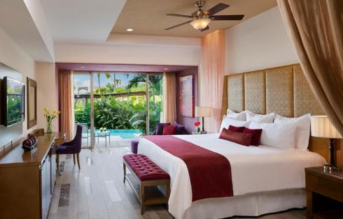 a hotel room with two beds and a large window at Secrets Vallarta Bay Resort & SPA - Adults Only in Puerto Vallarta