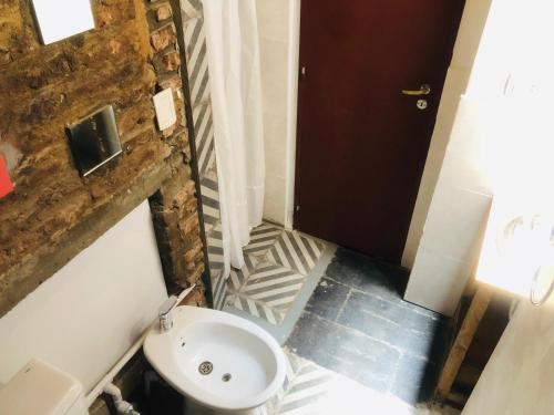 a small bathroom with a sink and a toilet at Casa Palacio, Arte e Historia in Buenos Aires