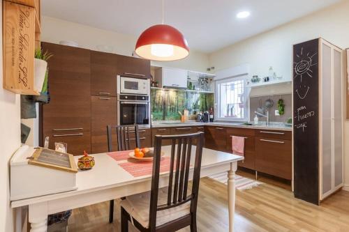 a kitchen with a table and a dining room at Women Only - Solo Mujeres in Seville