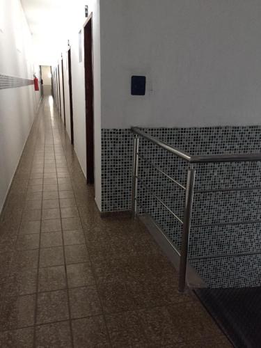 a hallway of a building with stalls and a walk way at Pousada Maré Mansa in Maceió