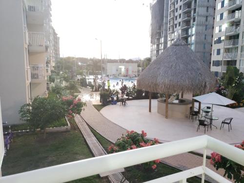 a view from a balcony of a patio with a umbrella at Piscina & Descanso - Puerto Azul- con todas las comodidades! in Ricaurte