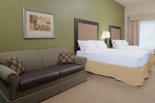 a hotel room with two beds and a couch at Holiday Inn Express Hotel & Suites North Sequim by IHG in Sequim