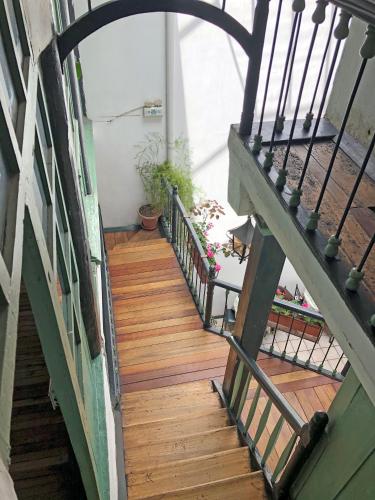an overhead view of a wooden staircase in a building at Hostal Latina in Cuenca