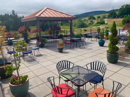 a patio with tables and chairs and a gazebo at Holiday Inn Express Hotel & Suites North Sequim by IHG in Sequim