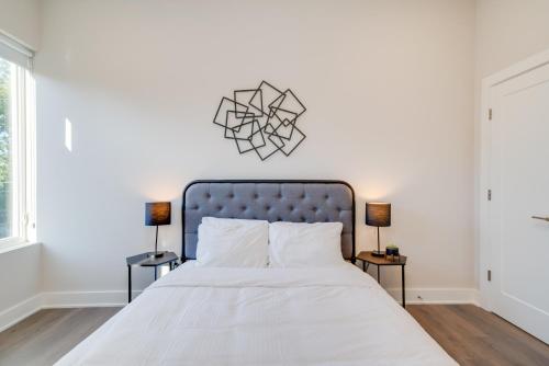 a bedroom with a bed with a blue headboard at Mason Lofts at West End in Nashville