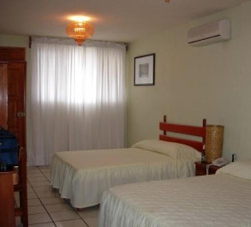 Cama ou camas em um quarto em Nakum Hotel