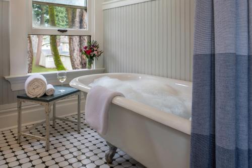 a white bath tub in a bathroom with a window at Inn at the Gorge in Hood River
