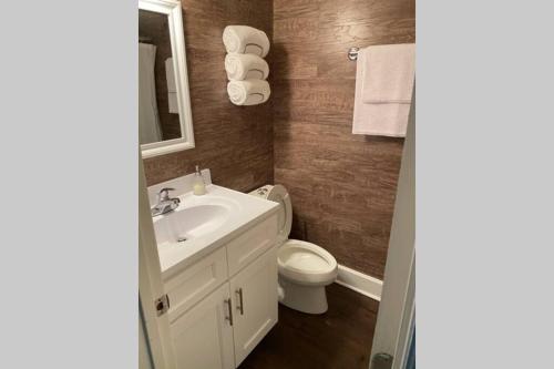 a bathroom with a white sink and a toilet at Belmont NC Riverfront 2-Bedroom Garden Suite in Charlotte