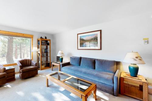 a living room with a blue couch and a table at The Summit 67 in Old Mammoth