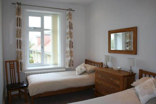 a bedroom with two beds and a window at Shanklin Manor in Shanklin