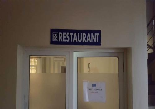 a blue sign above the doors of a building at BENIN CITY CENTER HOTEL in Cotonou