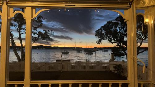 a view of a sunset from a gazebo at Paradise on The Strand in Russell