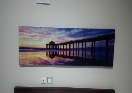 a painting of a pier hanging on a wall at BENIN CITY CENTER HOTEL in Cotonou