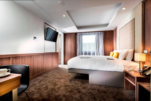 Giường trong phòng chung tại Hougoumont Hotel Fremantle