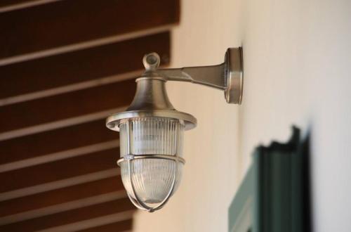 a light hanging on a wall in a room at Lefkas Petra in Agios Nikitas