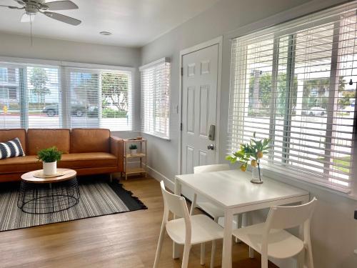 a living room with a table and a couch at Steps To The Beach, Main Street and Pacific City - OCEAN VIEWS in Huntington Beach