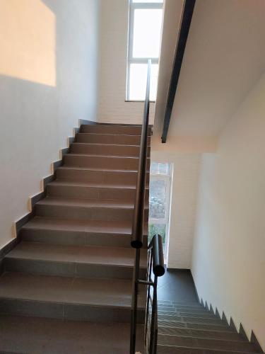 a staircase in a house with a window at theApartments Manufaktura in Łódź