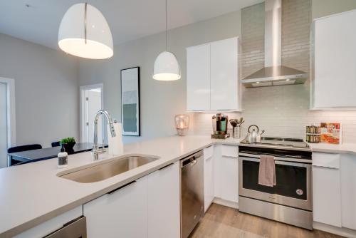 a kitchen with white cabinets and a sink at Mason Lofts at West End in Nashville