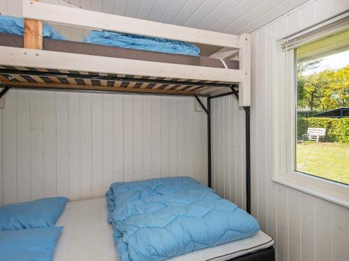 a bedroom with two bunk beds and a window at 7 person holiday home in Ulfborg-By Traum in Ulfborg