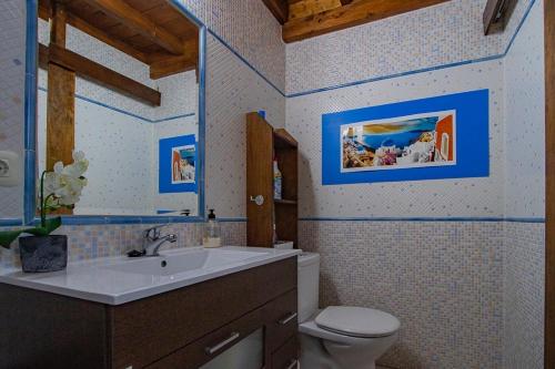 a bathroom with a white sink and a toilet at Loft Sofi in Morro del Jable