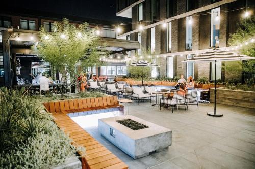a courtyard with tables and chairs in a building at ARRIVE Austin in Austin