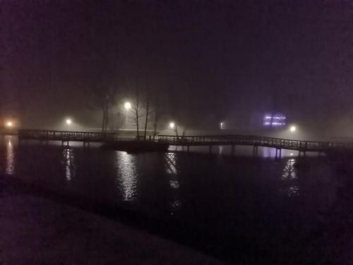a bridge over a body of water at night at Willa Katarzynka in Wisła