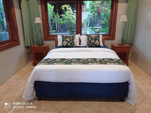 a bedroom with a large bed with a large window at Absolute Beachfront, Paradise, 3BR Villa with Private Pool on 1200m2 of Tropical Land in Tulamben