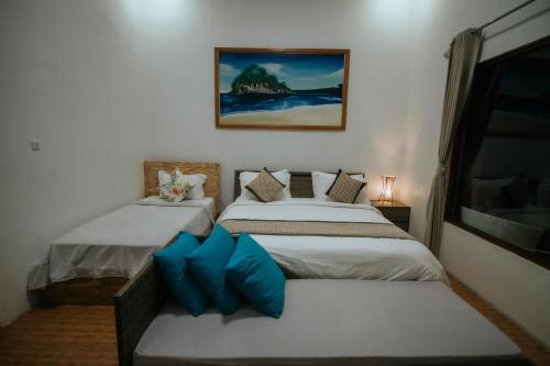 A bed or beds in a room at Pandawa Resort & Spa Seaview