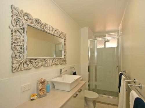 a bathroom with a sink and a mirror on the wall at Yamba Daze Sunset in Yamba