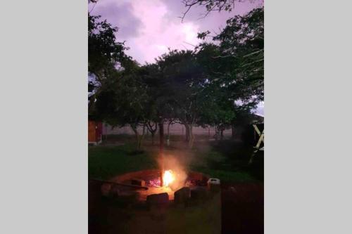 a fire pit in a yard at night at Cabins Sodwana Bay - antibootika in Sodwana Bay