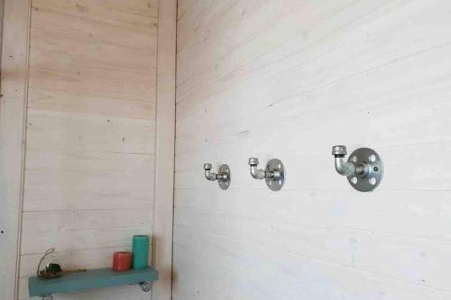a bathroom with two faucets on a wall at Cabins Sodwana Bay - antibootika in Sodwana Bay